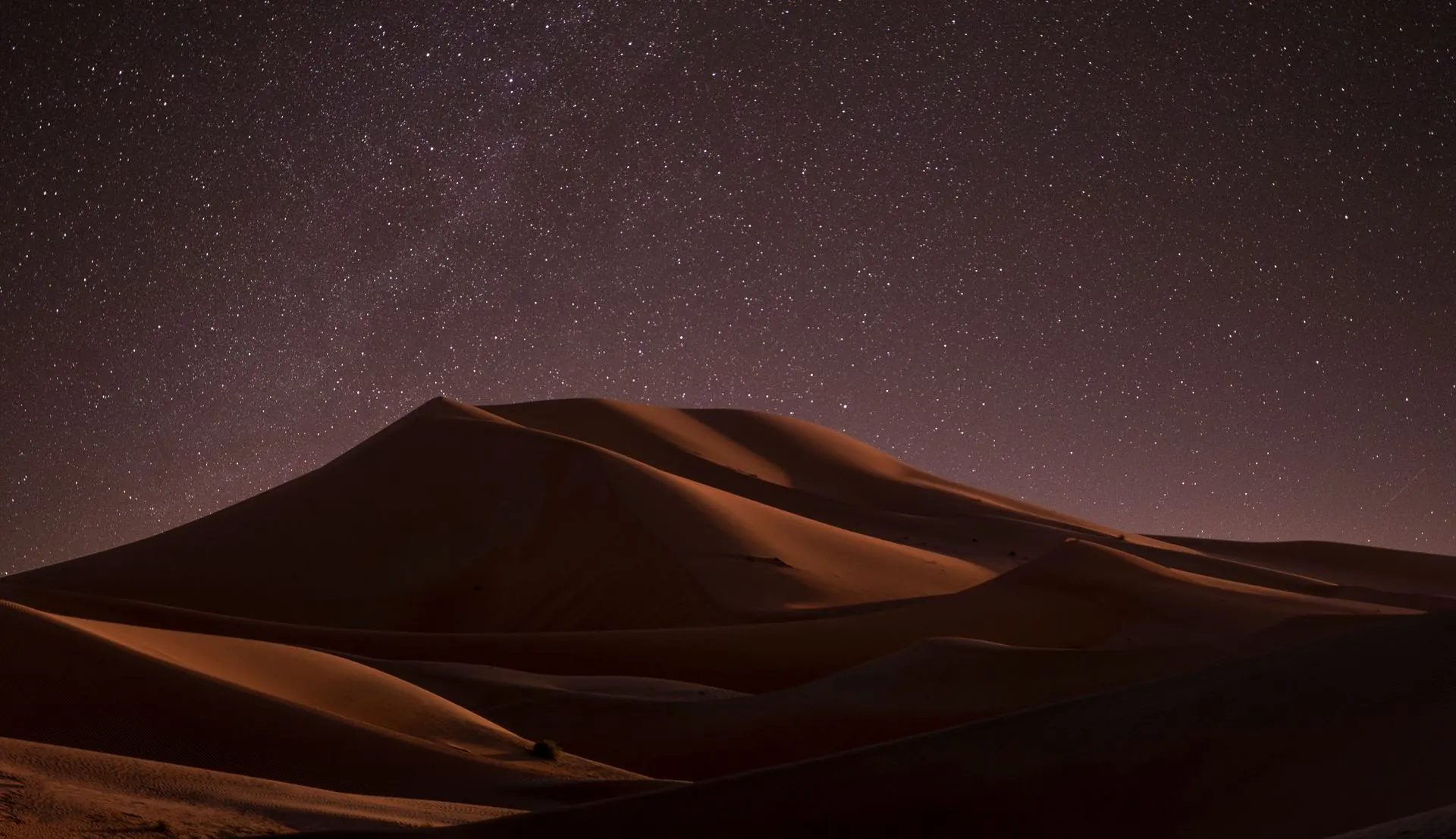 Night sky over desert dunes
