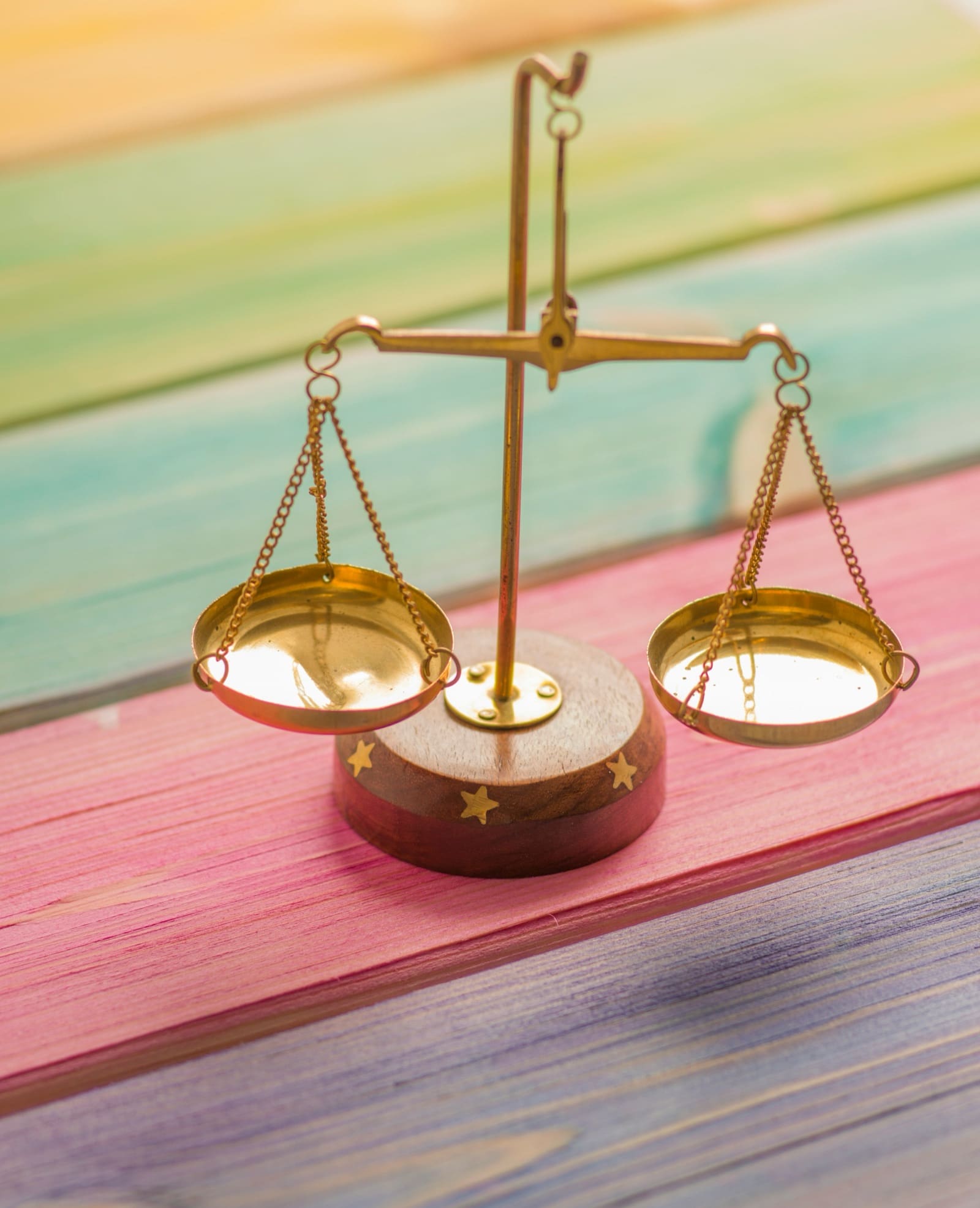 Small brass balance scale on a wooden surface